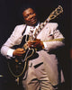 BB King performing on stage with black Les Paul guitar in grey suit photo print