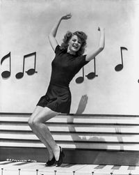 Rita Hayworth dancing with musical notes background photo print