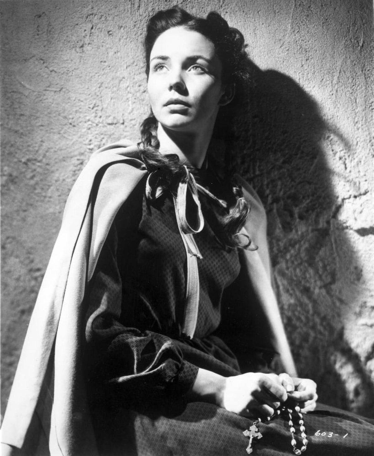 Jennifer Jones holding a holy rosary photo print.