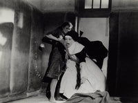 Film still of Audrey Hepburn dressed as a nun in a cell.