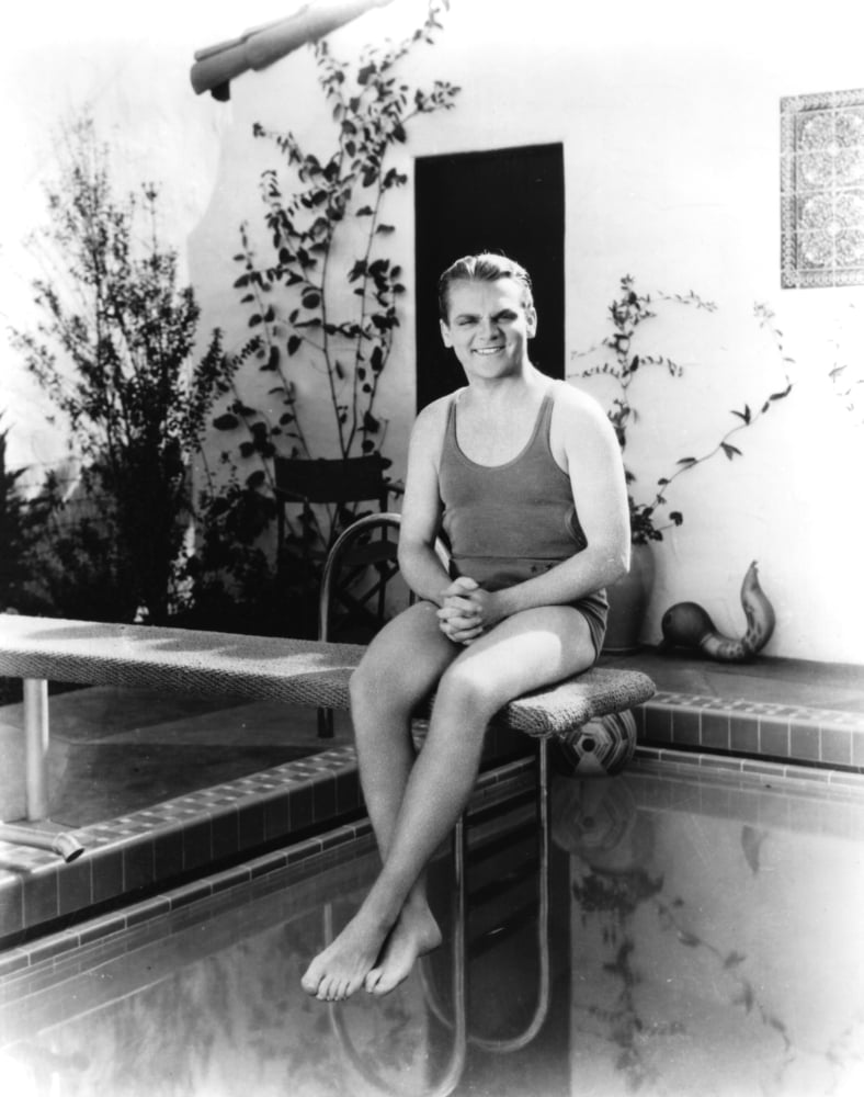 Vintage photo print of James Cagney on a diving board in a bathing suit.