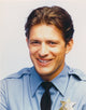 Costas Mandylor smiling in police outfit photo print