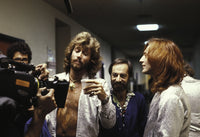 The Bee Gees photo print featuring iconic music legends in front of a camera.