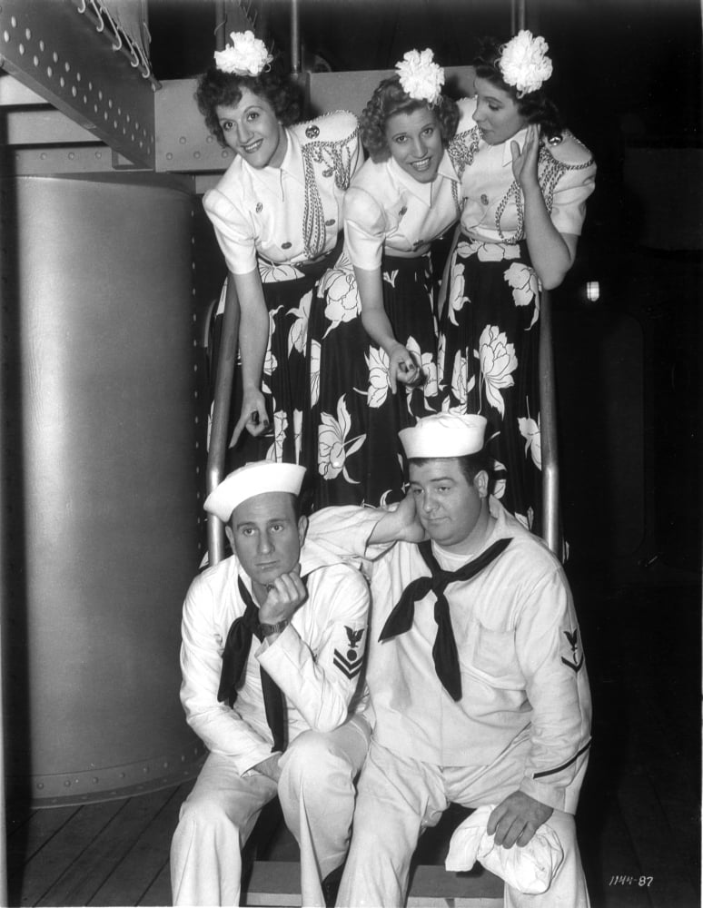 Vintage photo print of The Andrews Sisters with sailors, capturing 1940s nostalgia.