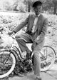 Morgan Freeman riding a bicycle on the set of Driving Miss Daisy photo print.