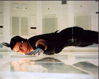 Tom Cruise suspended above floor in Mission: Impossible photo print.