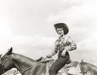 Black and white photo print of Jane Russell riding a horse.