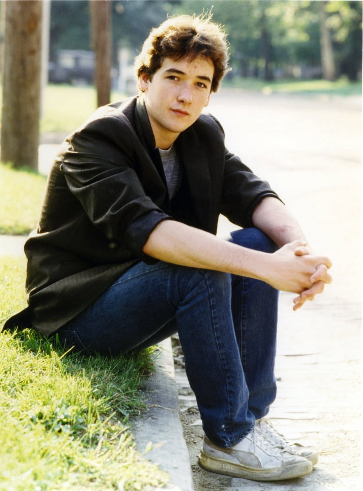 John Cusack sitting on the sidewalk photo print.