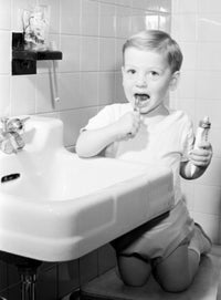 Boy Brushing Teeth in Bathroom Fine Art Print