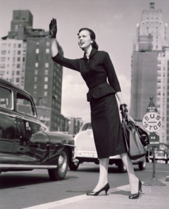 Low Angle View of a Young Woman Hailing a Taxi Fine Art Print