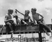 Low Angle View of Three Boys Fishing Fine Art Print