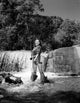 Young Woman Fly Fishing in Stream Fine Art Print