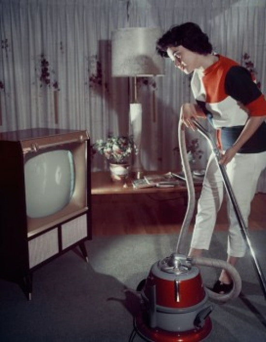 Side Profile of a Young Woman Using a Vacuum Cleaner Fine Art Print
