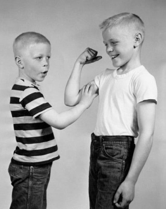 Boy Touching His Brother's Biceps Fine Art Print
