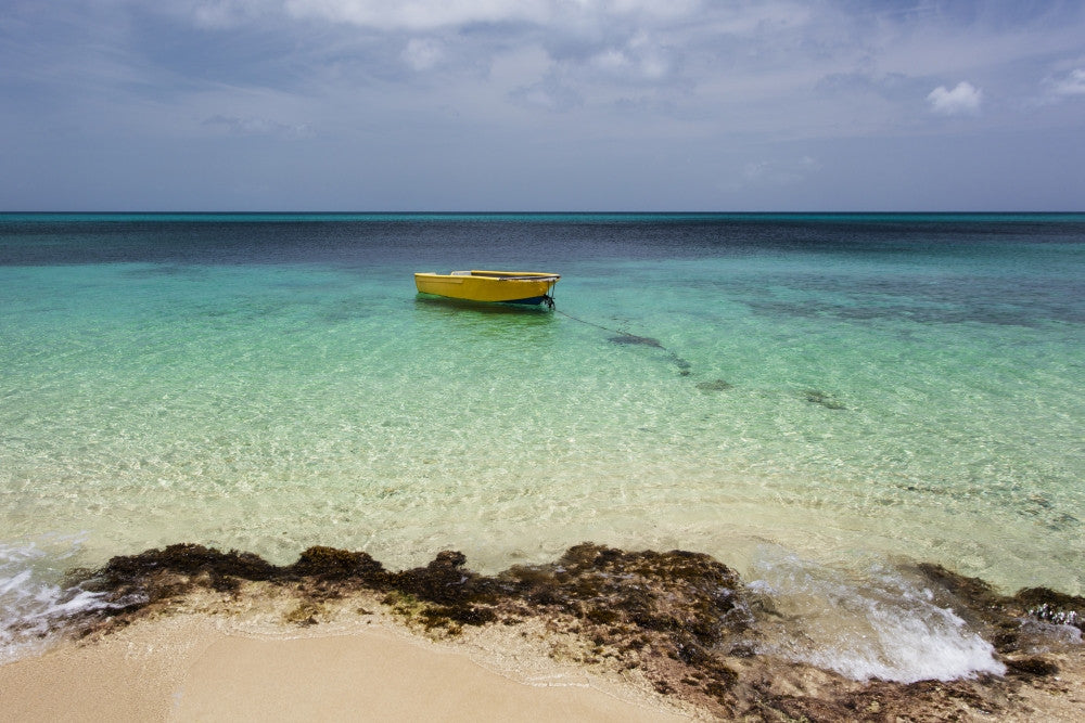 Lone Boat in Turquoise Waters - Frederiksted, St. Croix Print by Jenna Szerlag