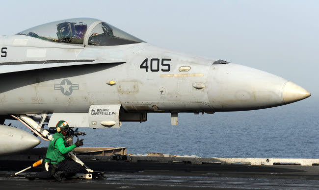 Aviation Boatswain's Mate Guiding F/A-18C Hornet Fine Art Print by Stocktrek Images