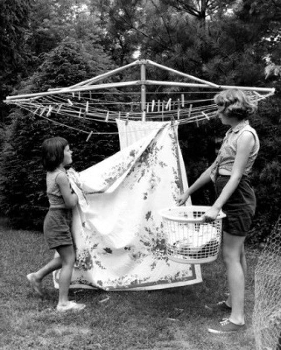 Mother and Daughter Hanging Laundry in Backyard Fine Art Print