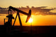 Silhouette of a Pump Jack at Sunrise Poster Print by Michael Interisano
