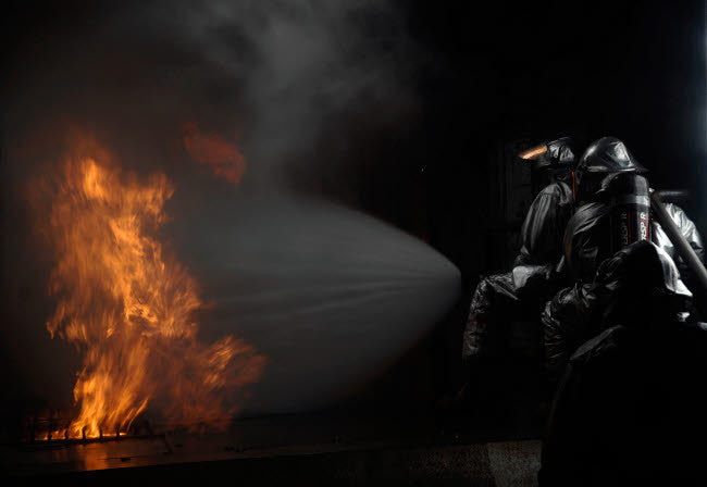Firefighters Extinguishing Simulated Cargo Fire at RAF Mildenhall Fine Art Print by Stocktrek Images