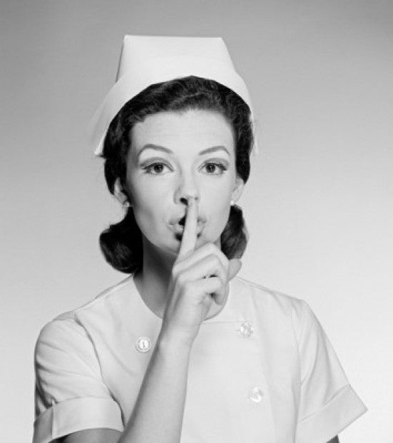 Studio Portrait of Female Nurse Gesturing Silence Fine Art Print
