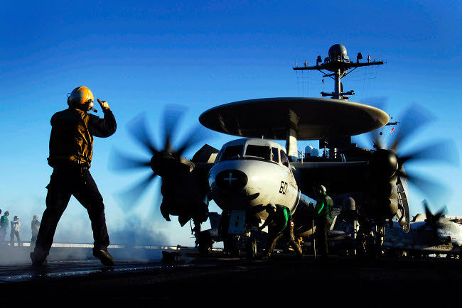 An Airman Guides an E-2C Hawkeye Fine Art Print by Stocktrek Images
