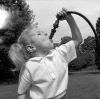 Girl Drinking from Garden Hose Poster Print - Fine Art