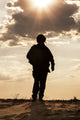 Silhouette of Young Soldier in Military Helmet Fine Art Print by Oleg Zabielin