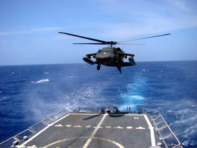 Army UH-60 Black Hawk Helicopter Landing Poster Print by Stocktrek Images