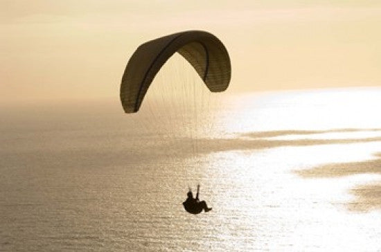 Silhouette of a Paraglider Over the Pacific Ocean Poster Print by Panoramic Images