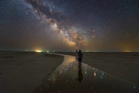 A Man Walking on the Salt River Under the Milky Way Fine Art Print by Yuri Zvezdny