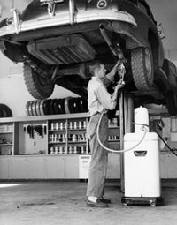 Mid Adult Man Repairing a Car in Auto Repair Shop Poster Print