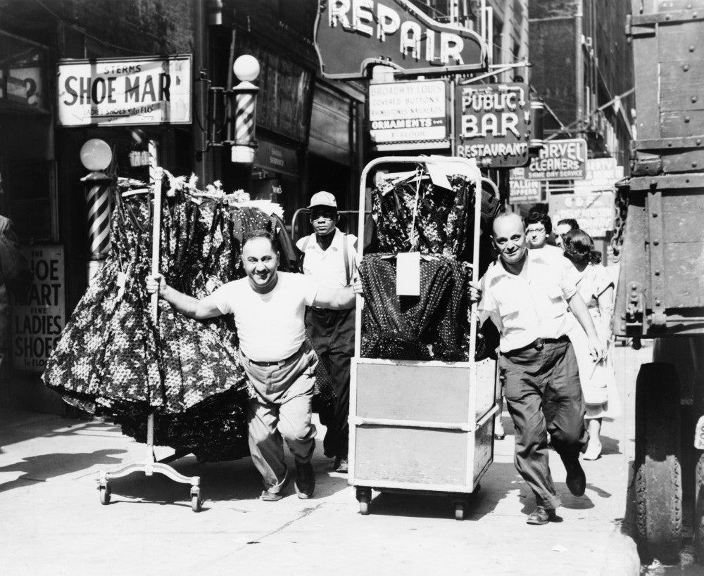 Men Pulling Racks of Clothing in the Garment District Poster Print