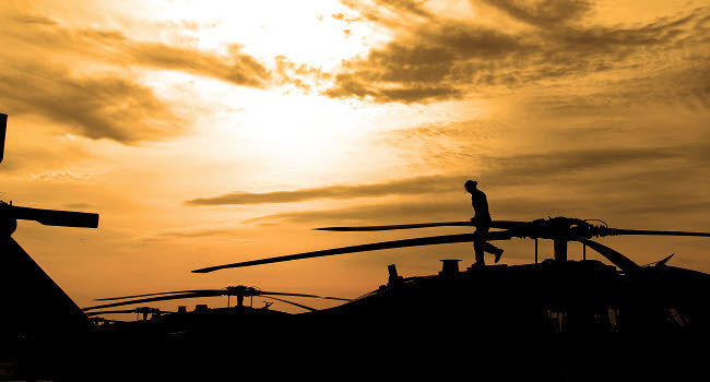 A Pilot Conducts a Pre-Flight Inspection on a UH-60 Black Hawk Helicopter Fine Art Print by Stocktrek Images