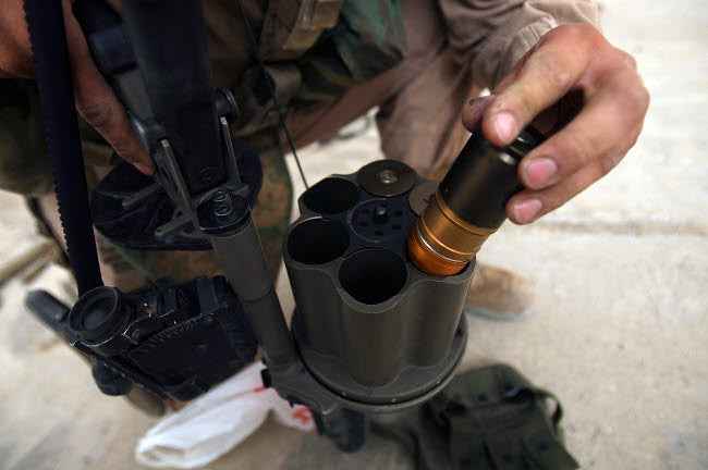 A Marine Loads 40 mm Grenades Fine Art Print by Stocktrek Images