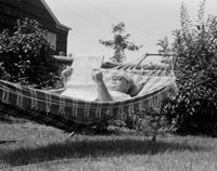Senior Man Relaxing in Hammock with Newspaper Fine Art Print