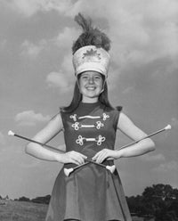 Smiling Drum Majorette Performing with Twirling Batons Poster Print