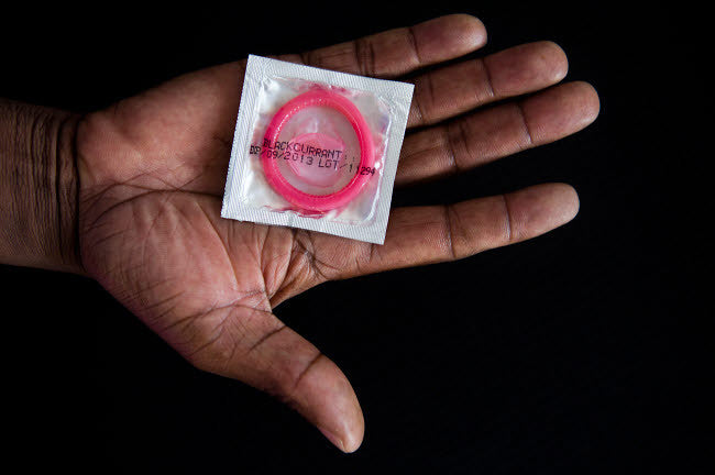 Human Hand Holding Male Condom Fine Art Print by VWPics