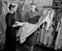 Woman Choosing Dress in Shop Fine Art Print - Multiple Sizes Available
