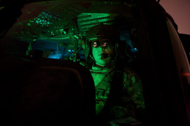 Pilot with Night Vision Goggles in UH-60 Blackhawk Cockpit Fine Art Print by Terry Moore