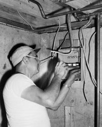 Side Profile of an Electrician Installing a Circuit Board Fine Art Print