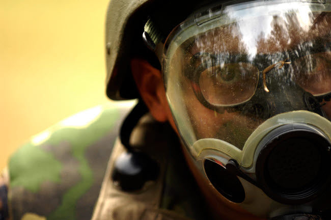 Airman in Gas Mask During Simulated Attack Fine Art Print by Stocktrek Images