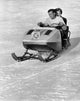 Mid Adult Couple Riding a Snowmobile Downhill Fine Art Print