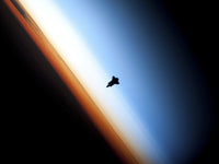 Silhouette of Space Shuttle Endeavour Over Earth's Horizon Poster Print