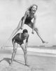 Young Couple Playing Leapfrog on the Beach Fine Art Print