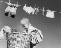 Side Profile of a Girl Looking into a Laundry Basket Fine Art Print