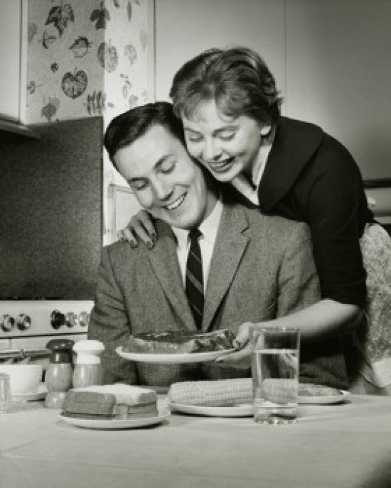 Young Woman Serving Steak to a Young Man Fine Art Print