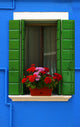 Vibrant Blue Building with Green Shutters Art Print by Carson Ganci