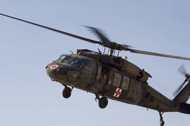 A UH-60 Blackhawk Medivac Helicopter Over Camp Warhorse Fine Art Print by Terry Moore