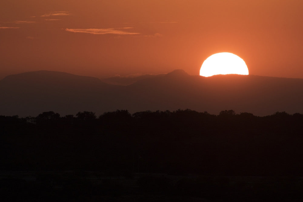 Setting Sun Over African Landscape Fine Art Print by Robert Postma