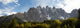 Panorama of Jagged Mountain Range with Glowing Trees Fine Art Print by Michael Interisano